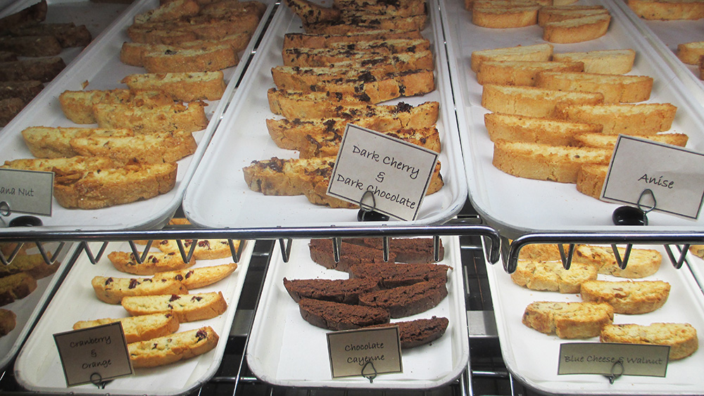 Cave Vineyard - indoor photo, of a standard bakery display case filled with several trays of various types of biscotti cookies.