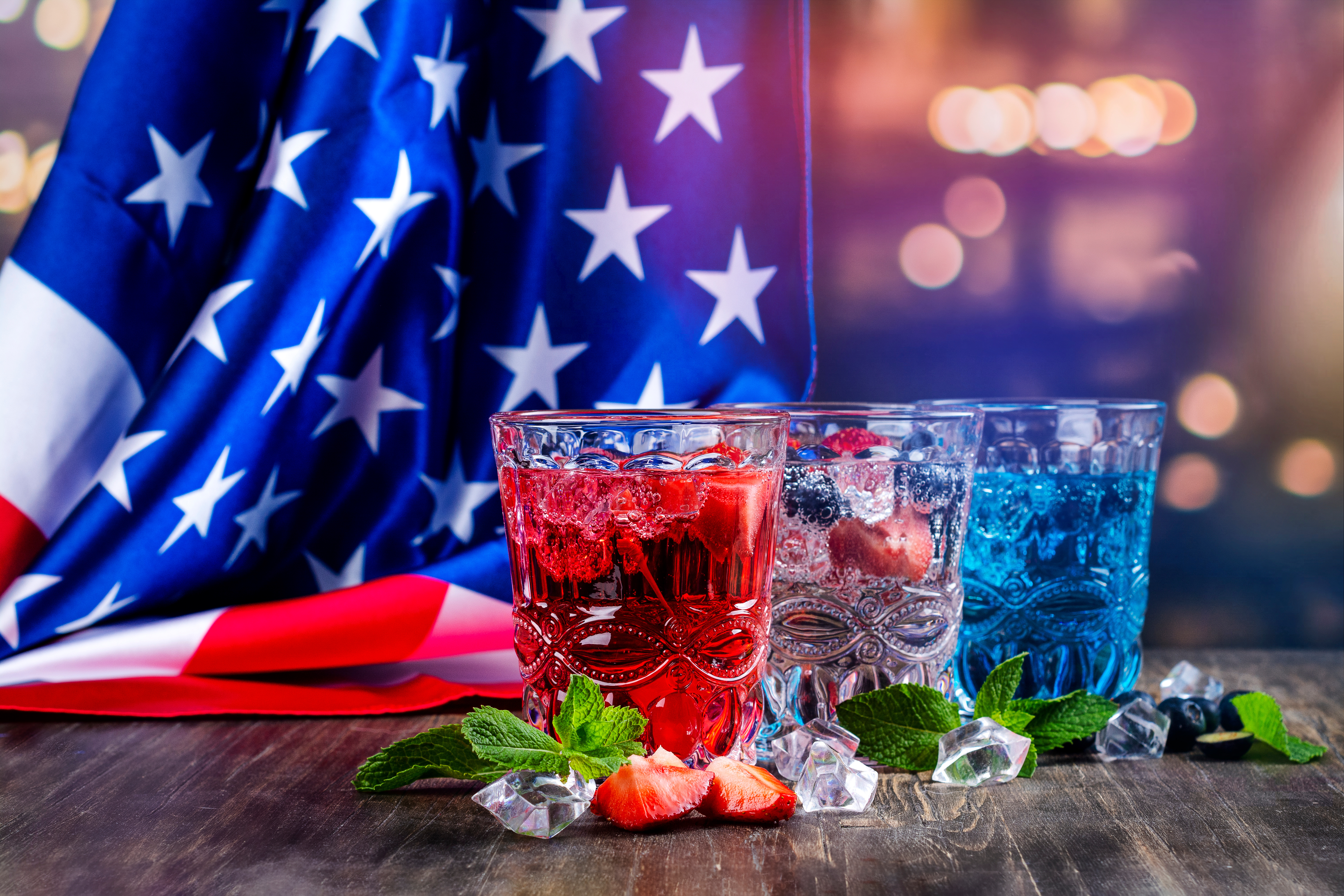 American flag hanging in the background with 3 glasses