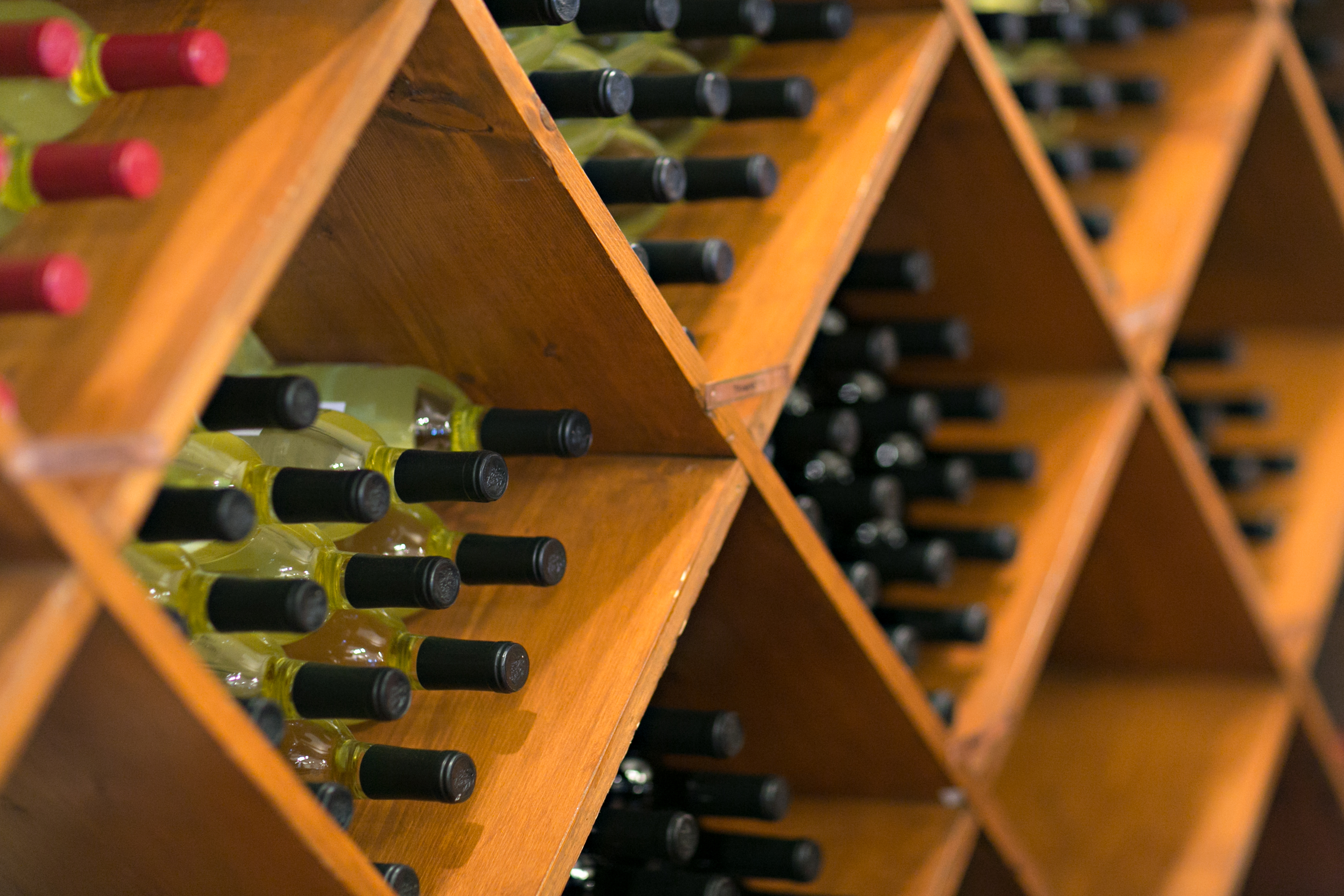 Wine storage rack in store with wine bottles.