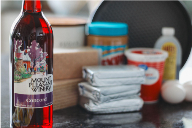 Wine bottle with cheesecake ingredients behind