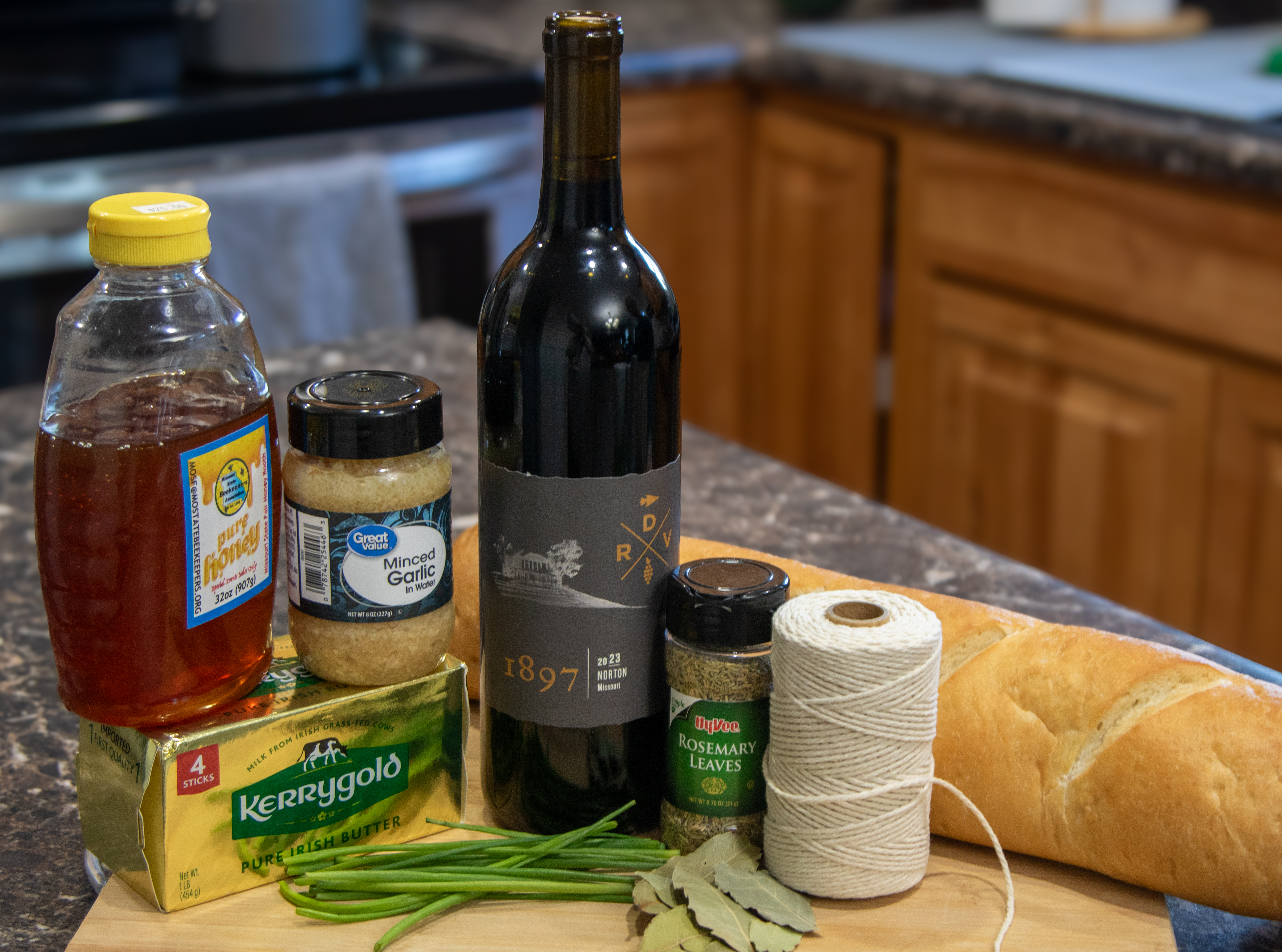 Ingredients: 1 cup Norton 1 sprig rosemary 1 bay leaf ½ tsp. honey 1 cup butter, softened to room temperature 1 clove garlic, minced Kosher salt Ground black pepper Kitchen twine 2 Tbsp. chopped chives