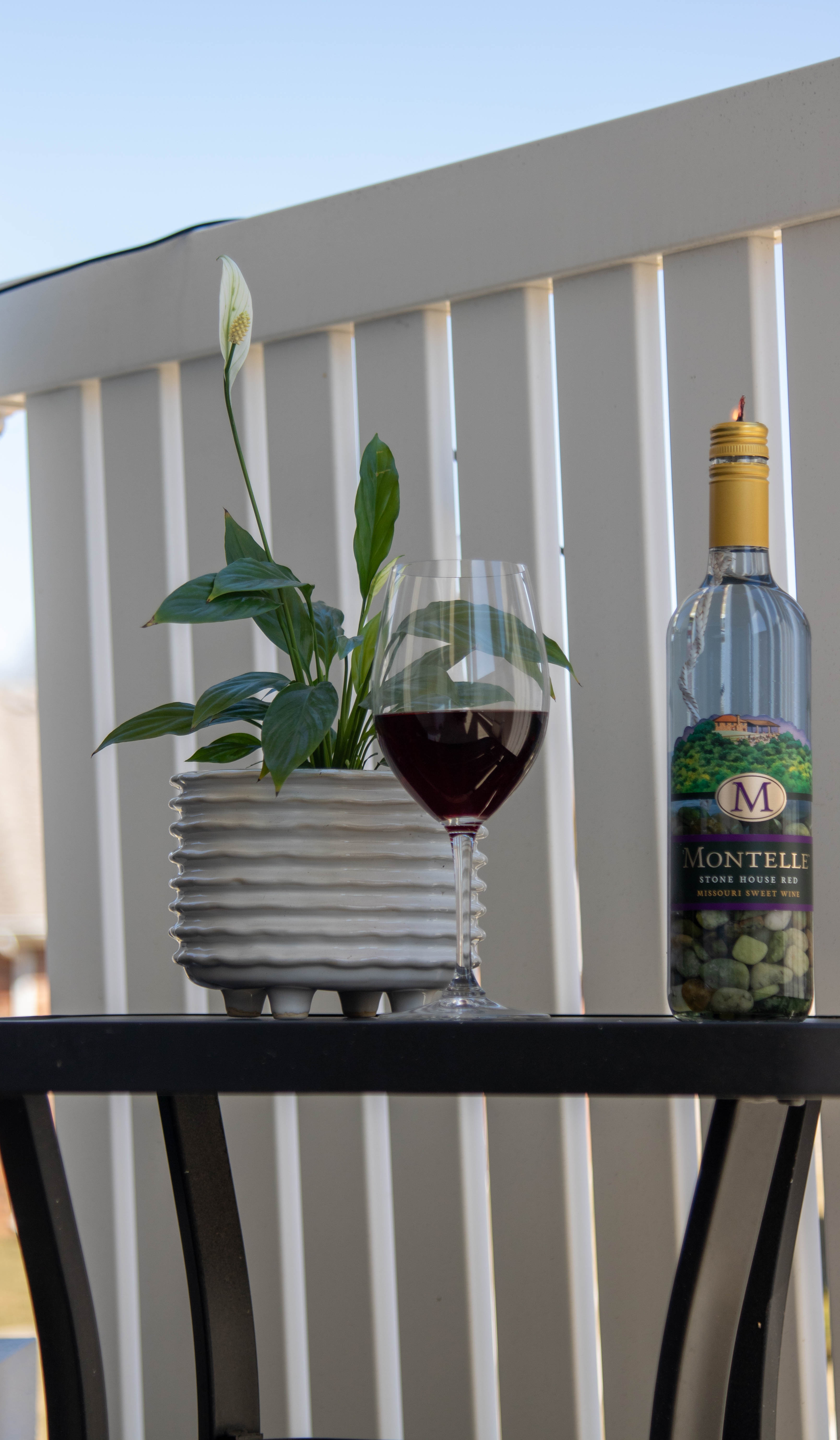 Wine bottle candle on patio