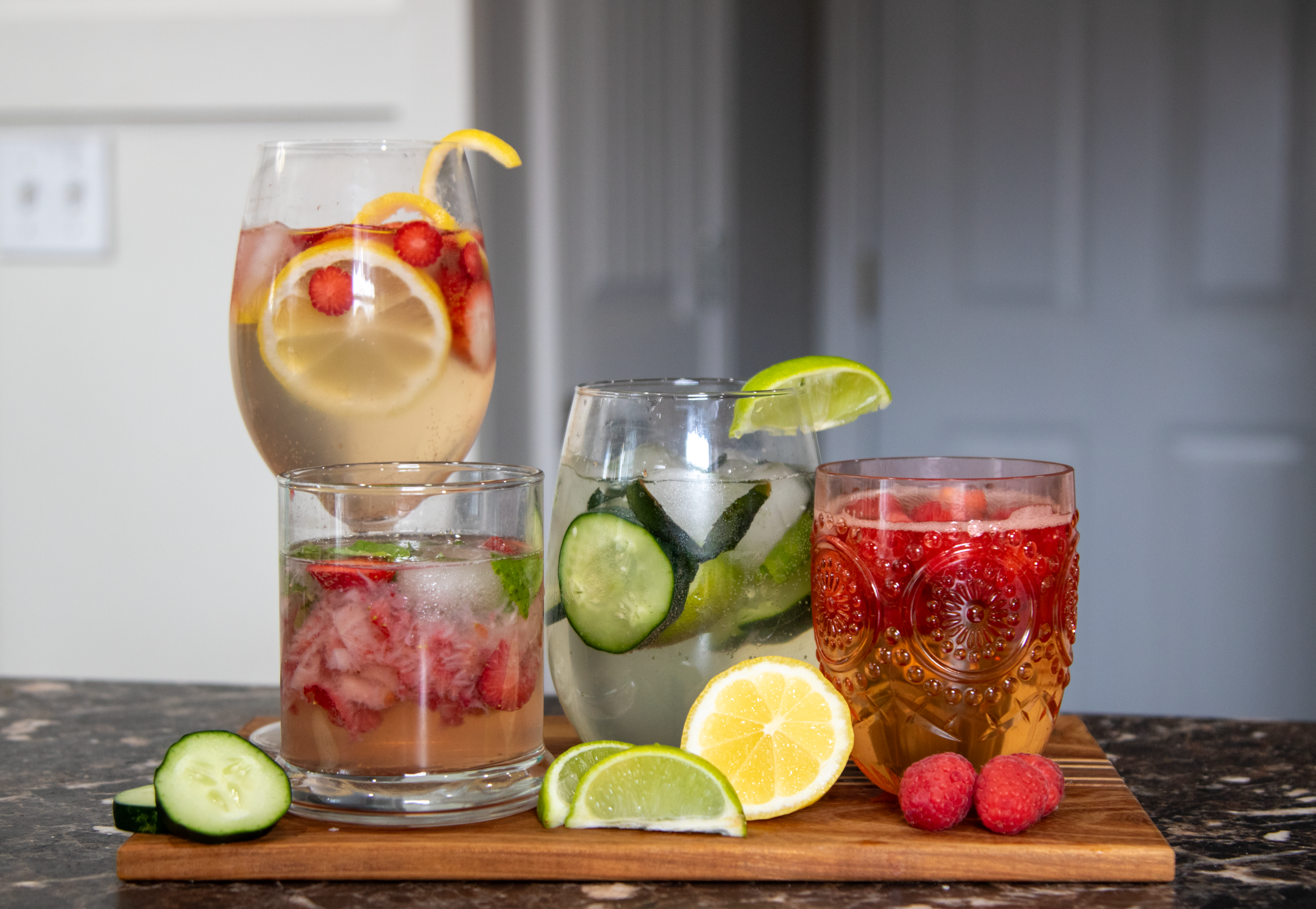 All 4 spring cocktails finished together on a cutting board.