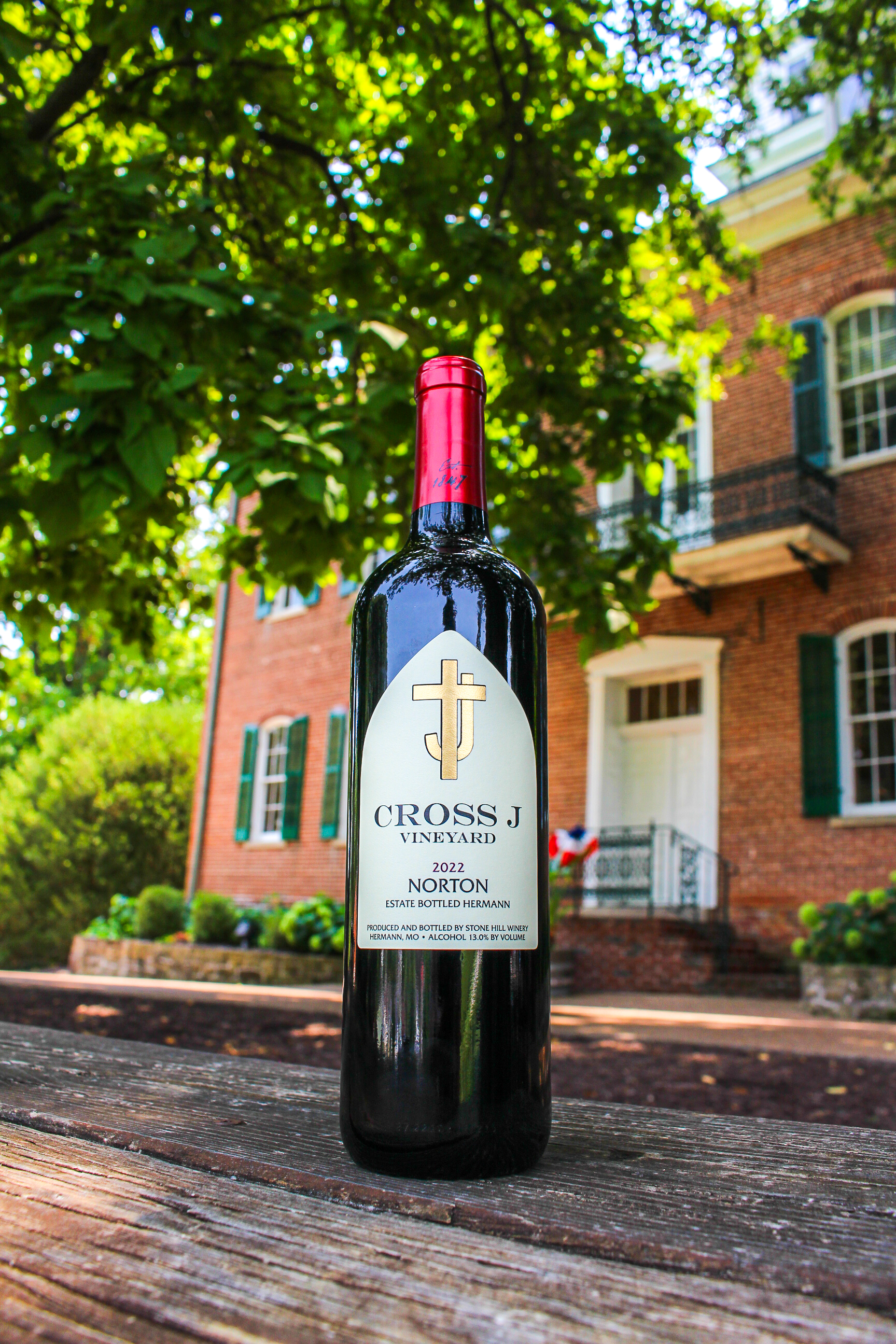 2022 Cross J Norton Wine bottle sitting on a picnic table