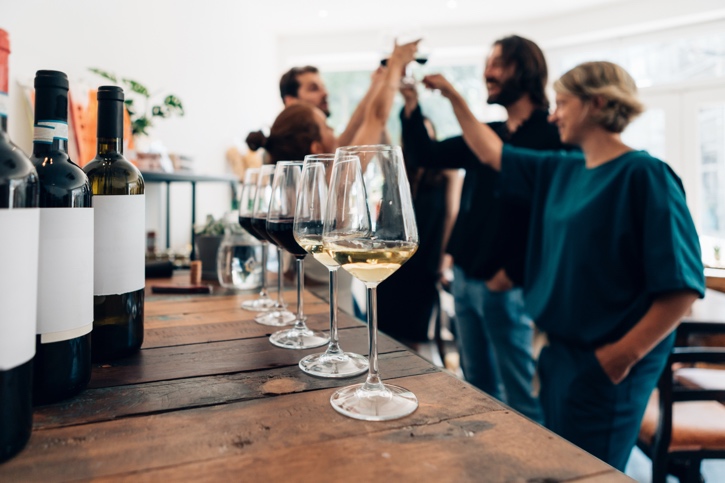 A group of people stand around a table with wine glasses
AI-generated content may be incorrect.